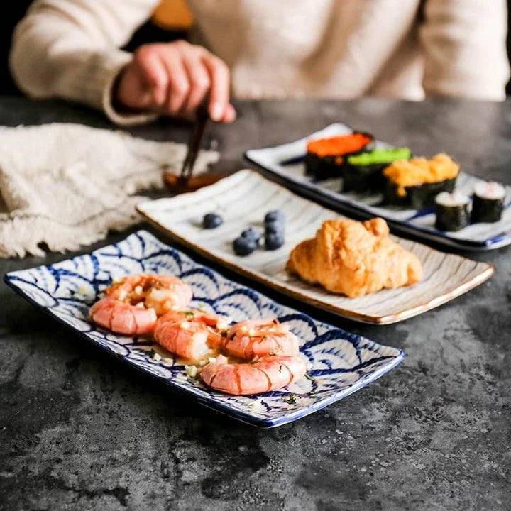 Japanese-inspired ceramic plate with blue and orange color design, featuring a gently curved shape for enhanced presentation of meals.