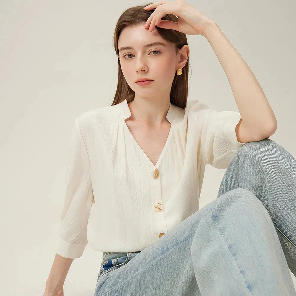 Photograph of a women's French V-neck loose, cozy style shirt in a creamy-white color