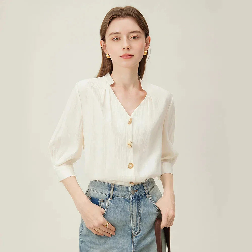 Photograph of a women's French V-neck loose, cozy style shirt in a creamy-white color