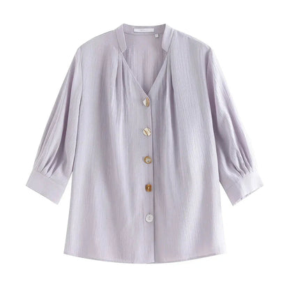 Photograph of a women's French V-neck loose, cozy style shirt in a creamy-white color