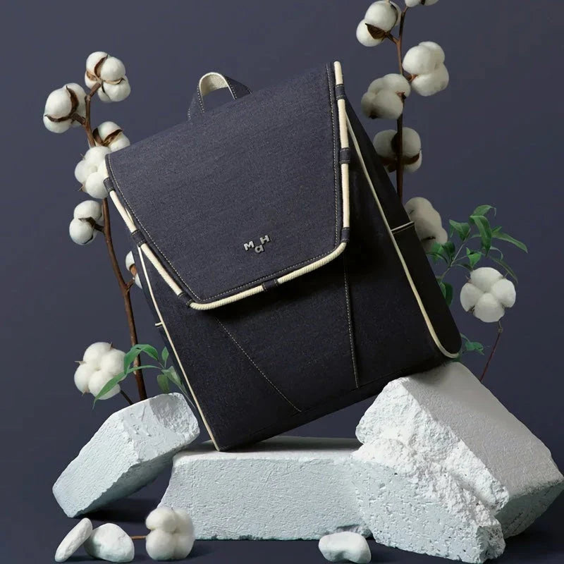 Eco-Friendly Active Denim Waterproof Backpack with multiple interior pockets, waterproof lining, and comfortable hard handle