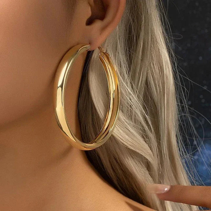 Glossy geometric metal hoop earrings in a silver finish, a trendy and versatile fashion accessory