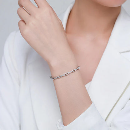 Elegant silver bracelet with a captivating wave-like design, a premium micro-set jewelry piece crafted with superior Seiko technology