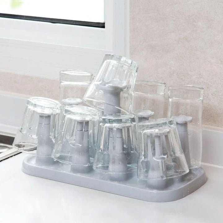 Flower-shaped mug holder rack in white, with 8 slots for organizing and displaying mugs on a kitchen countertop