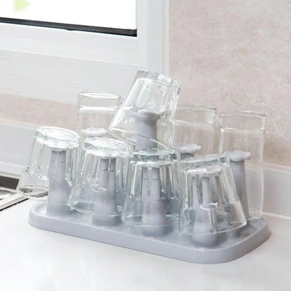 Flower-shaped mug holder rack in white, with 8 slots for organizing and displaying mugs on a kitchen countertop
