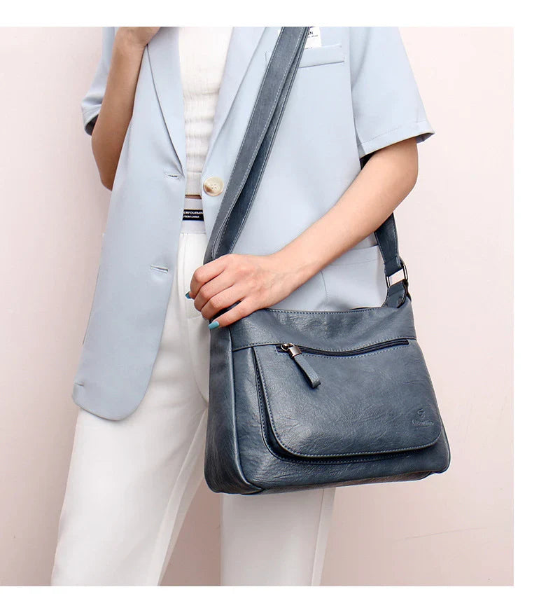 Stylish one-shoulder messenger bag in various colors with a soft, supple PU leather exterior and a spacious, organized main compartment