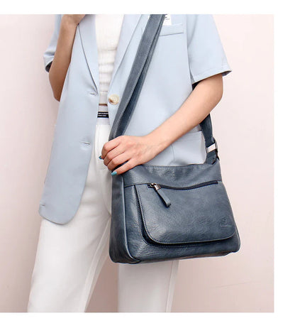 Stylish one-shoulder messenger bag in various colors with a soft, supple PU leather exterior and a spacious, organized main compartment