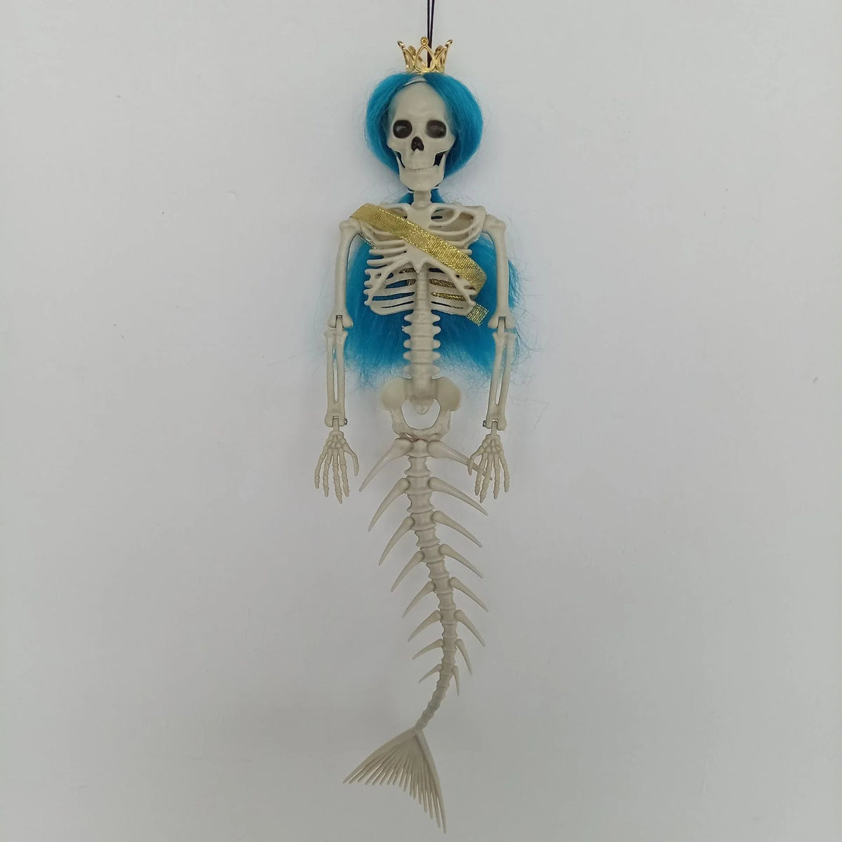 Mermaid bone pendant in various colors, including brown, dark purple, burgundy, and lake blue, hanging outdoors for Halloween decoration