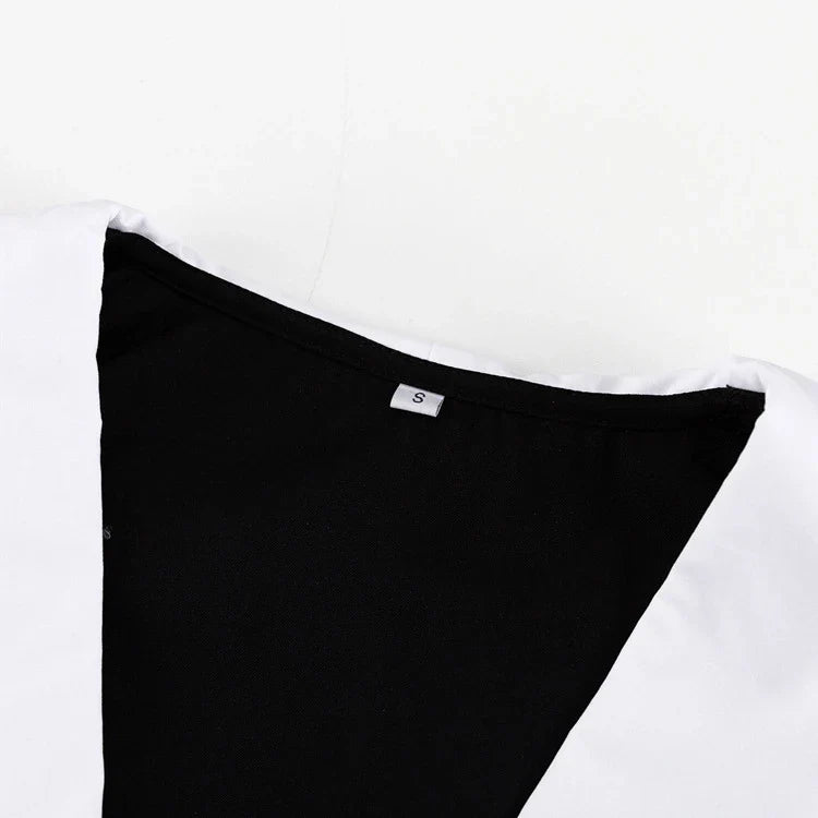Black and white color-blocked dress with long sleeves and a doll collar, showcasing a timeless and sophisticated style.