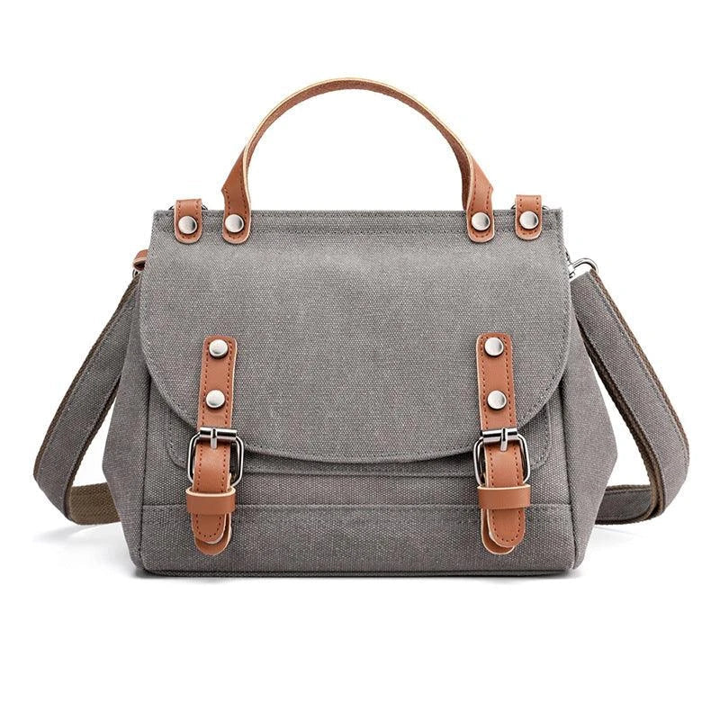 A stylish women's canvas crossbody handbag in an orange color, featuring a small square shape and a horizontal design.