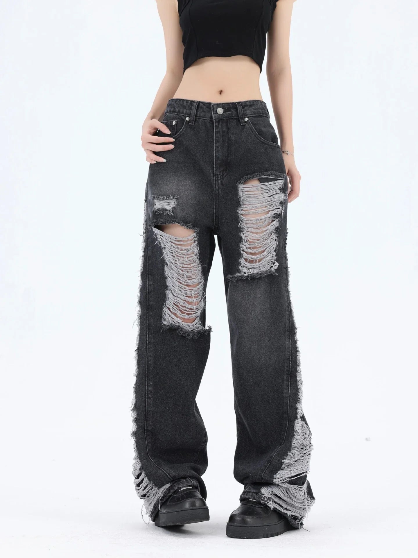Premium loose fit distressed denim trousers for men and women, featuring a relaxed silhouette, high-quality cotton construction, and trendy distressed details.
