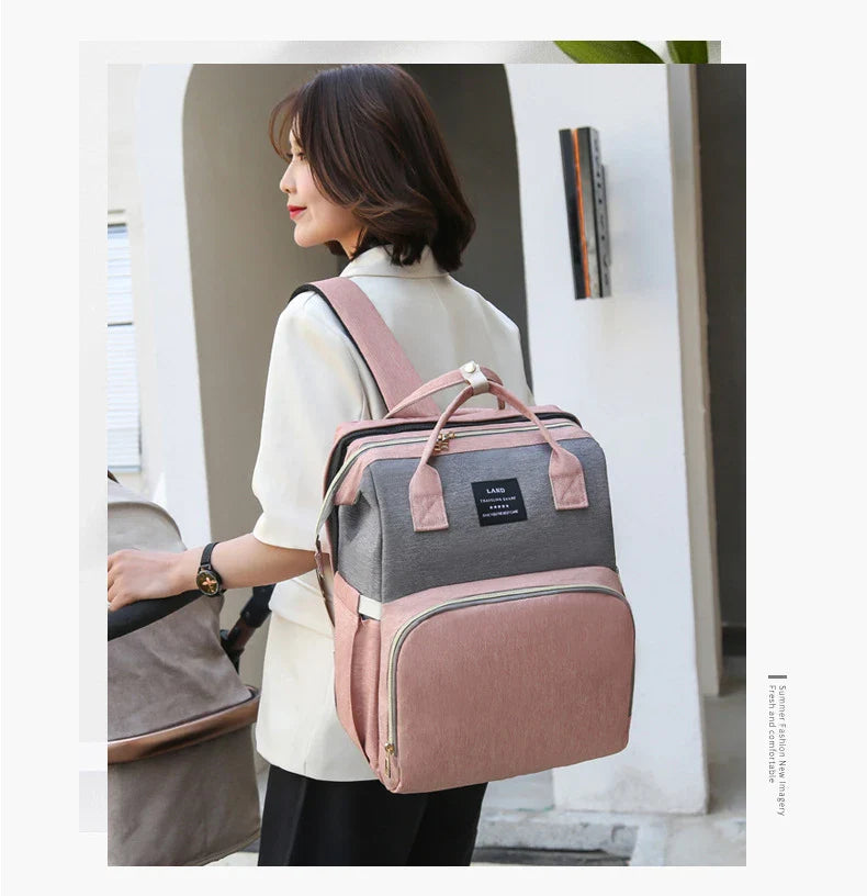 Multifunctional maternity diaper backpack with detachable crib, large capacity, and water-resistant design for travel