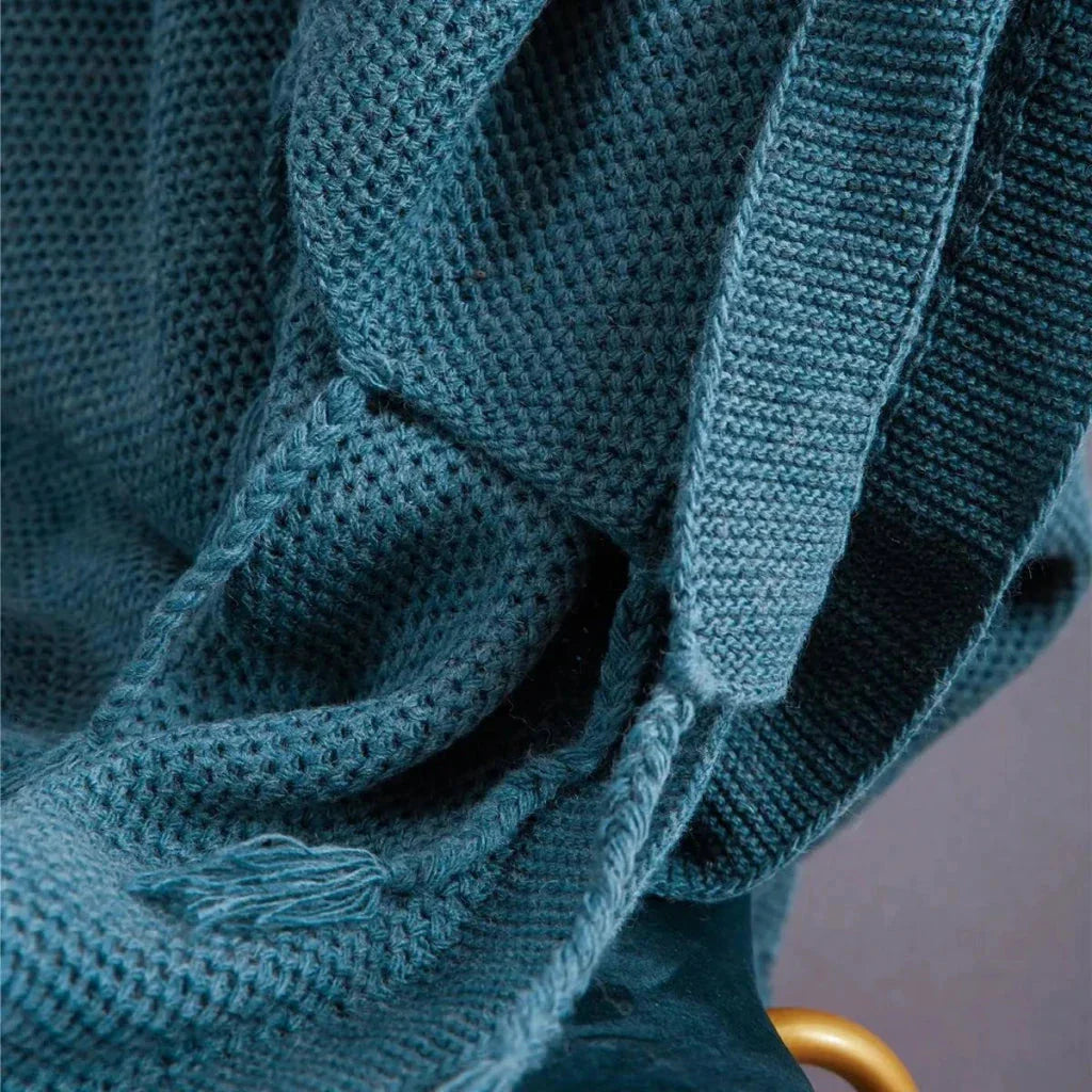 Luxurious Nordic wool knitted throw blanket with tassels in a solid gray color, a cozy and elegant home decor accessory