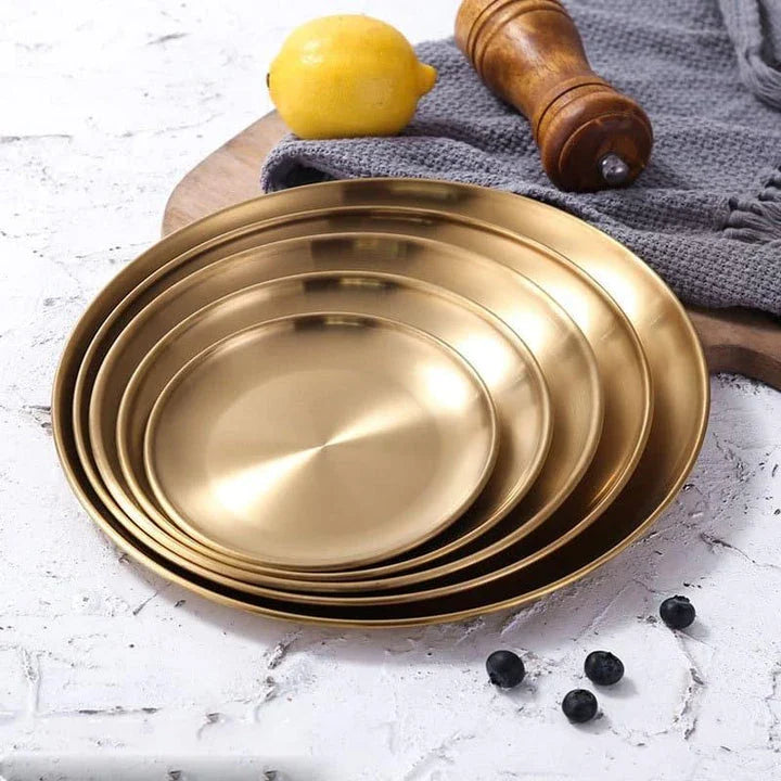 Elegant European-style round dinner plates made of premium stainless steel with a luxurious gold finish