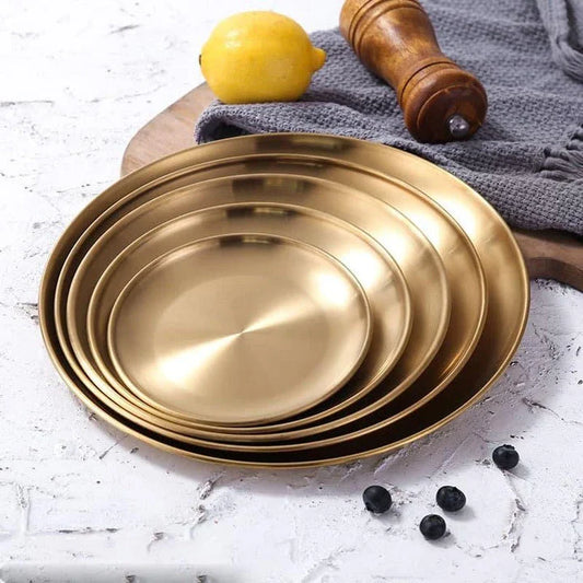 Elegant European-style round dinner plates made of premium stainless steel with a luxurious gold finish
