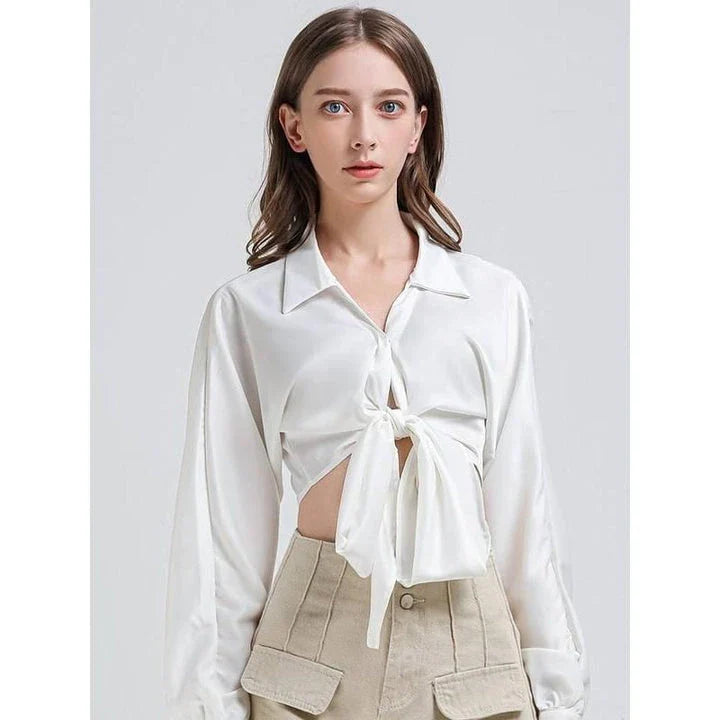 Elegant white vintage-inspired crop blouse with v-neck and long sleeves, a timeless and versatile wardrobe essential