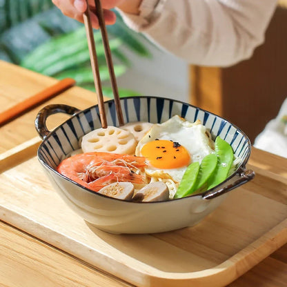Elegant porcelain noodle and soup bowl with a comfortable handle, perfect for serving a variety of hot and cold dishes.