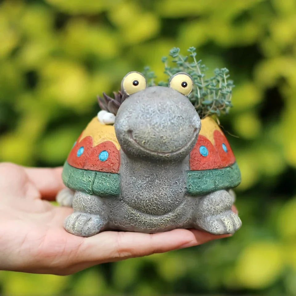 Charming gray cartoon turtle planter holding small potted succulents and cacti