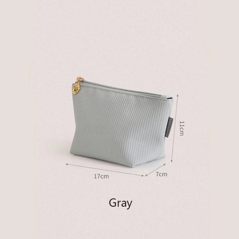 Mini portable waterproof cosmetic bag in beige and gray colors with a foldable design for convenient storage