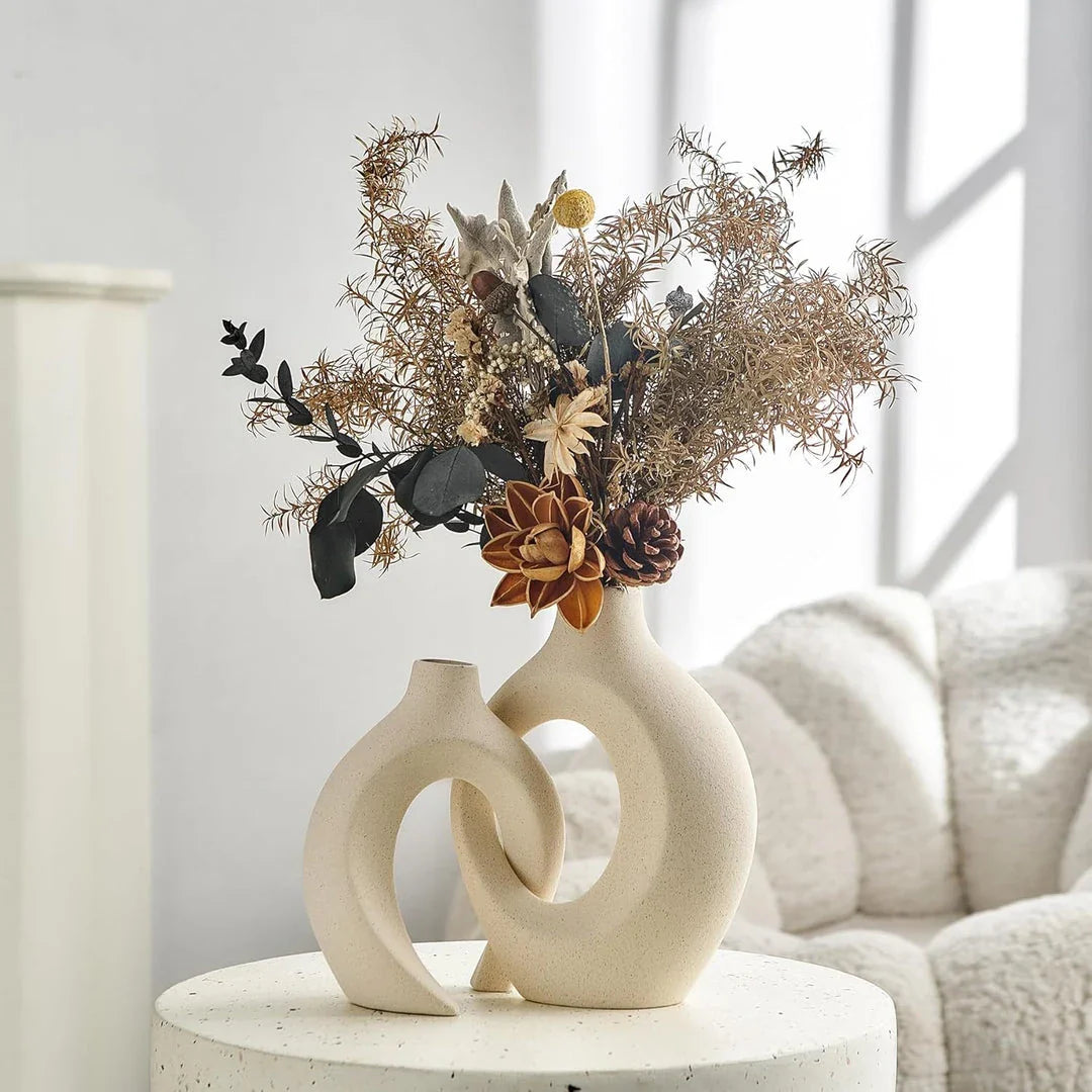 A set of two modern, minimalist white ceramic vases with a textured finish, designed to elevate any home decor.