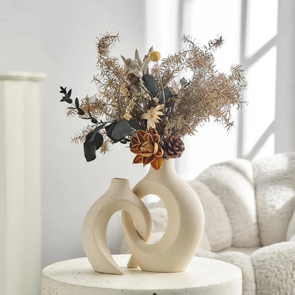 A set of two modern, minimalist white ceramic vases with a textured finish, designed to elevate any home decor.