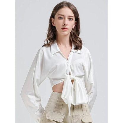 Elegant white vintage-inspired crop blouse with v-neck and long sleeves, a timeless and versatile wardrobe essential