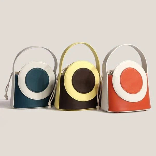 Chic color block vegan leather bucket bag with adjustable strap, perfect for everyday use and special occasions