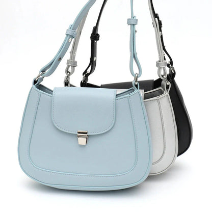 Elegant vegan leather shoulder bag with unique saddle shape, adjustable strap, and secure press lock closure