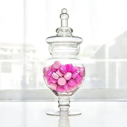 A transparent glass candy jar with an airtight lid, suitable for weddings, parties, and home decor