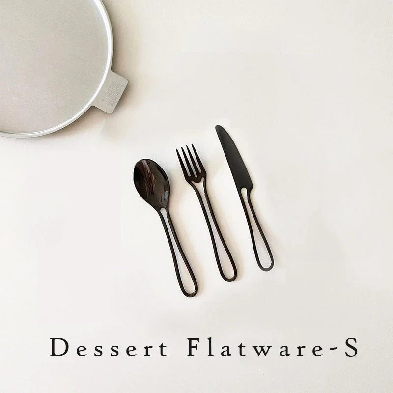 Sleek and modern 304 stainless steel cutlery set with a black finish, including knife, fork, and spoon for dinner and dessert.