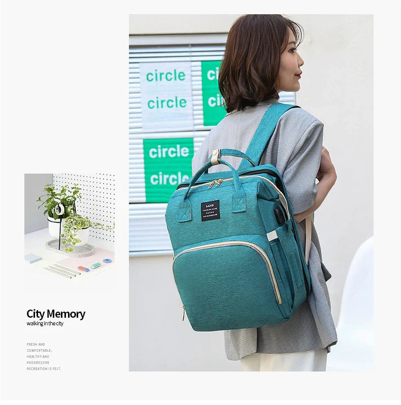 Multifunctional maternity diaper backpack with detachable crib, large capacity, and water-resistant design for travel