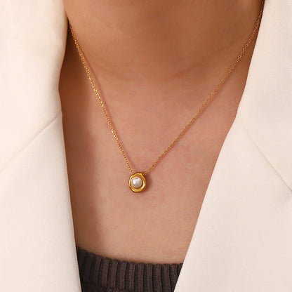 Elegant stainless steel pearl pendant necklace with a geometric design, perfect for women's fashion and everyday style.