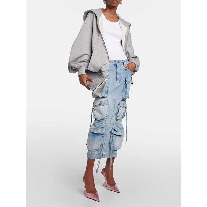 A high-waisted denim skirt with a distressed ribbon slit, perfect for adding a touch of fashionable flair to your spring wardrobe.