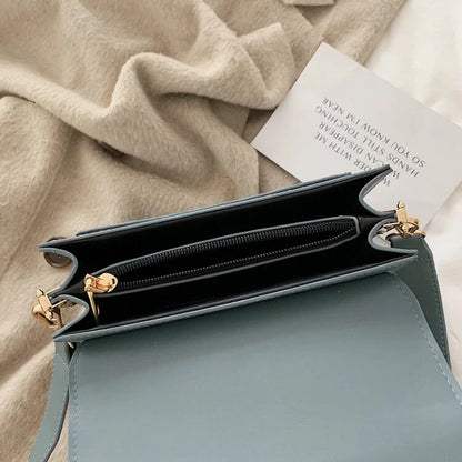 Stylish black crossbody shoulder bag with adjustable strap and multiple interior compartments for modern women