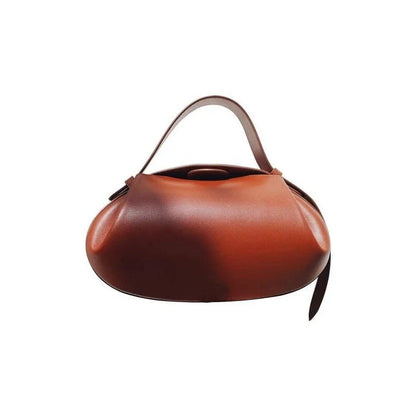 Circular vegan leather handbag in a tan color, with a sturdy build and thoughtful interior design for versatile use.