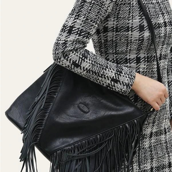 Chic vegan leather shoulder bag with tassel decoration, featuring a spacious interior and versatile carrying options