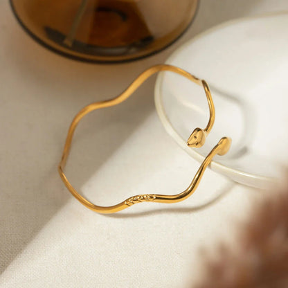 18K gold-plated stainless steel wavy snake bracelet with vintage-inspired design and open cuff style
