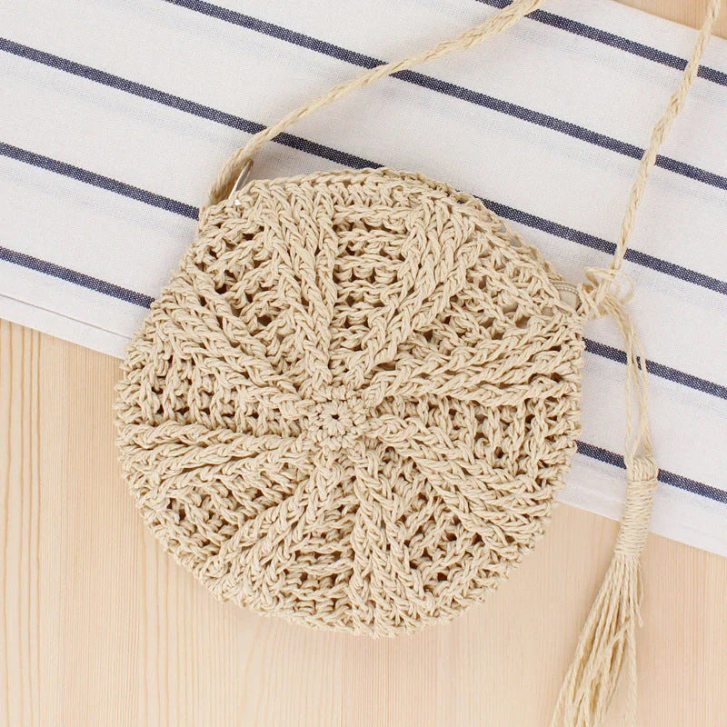 Bohemian rattan round crossbody bag in beige color with tassel accent, perfect for summer outings and beach parties