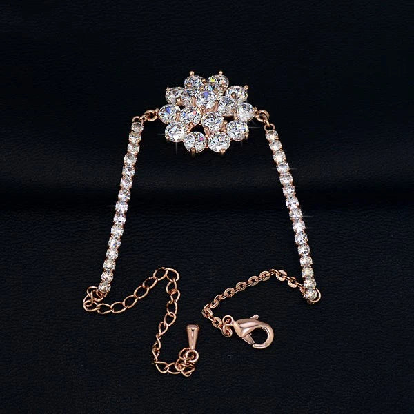 Elegant rose gold cubic zirconia bracelet with intricate cross, crown, and Roman numeral design