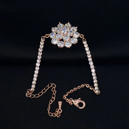 Elegant rose gold cubic zirconia bracelet with intricate cross, crown, and Roman numeral design