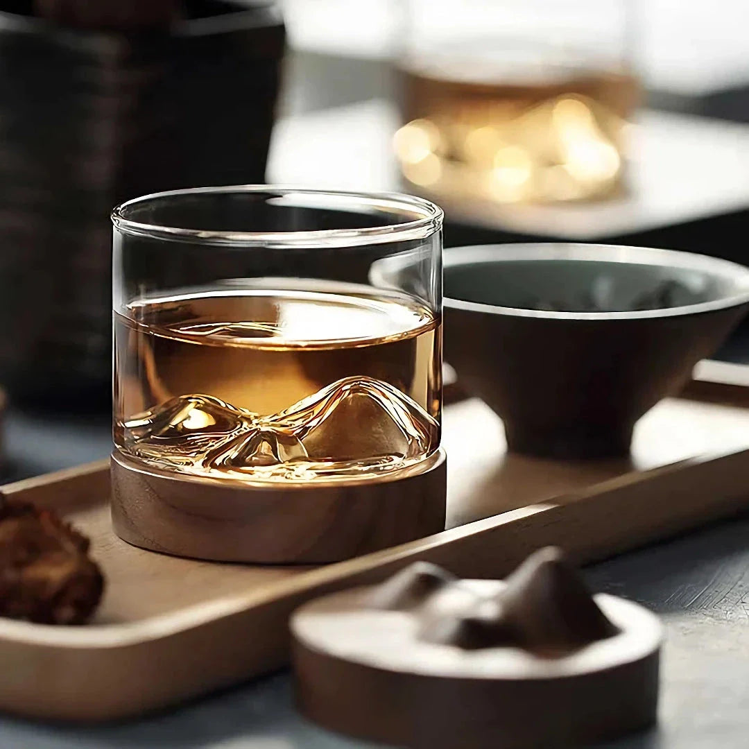 Elegant mountain-inspired whiskey glass with a wooden base, perfect for enjoying a variety of hot and cold beverages