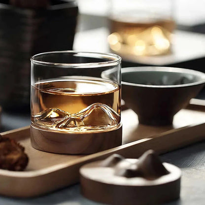 Elegant mountain-inspired whiskey glass with a wooden base, perfect for enjoying a variety of hot and cold beverages