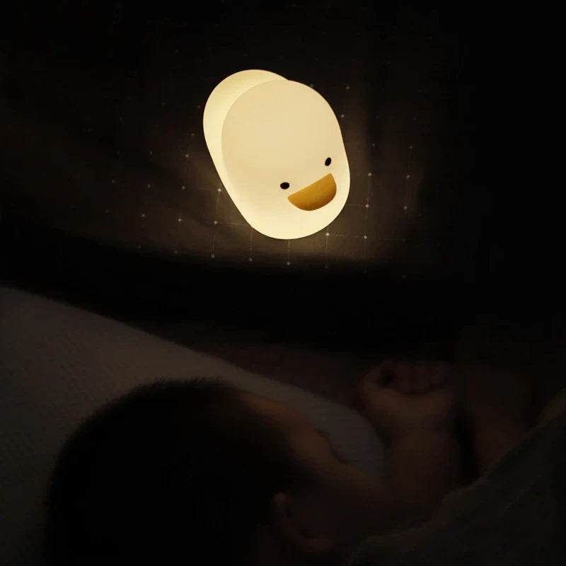 Cute duck-shaped LED night light with silicone and ABS construction, USB charging, and adjustable brightness