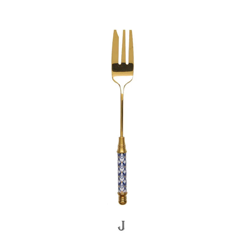 Elegant gold-plated dessert fork with intricate ceramic handle design