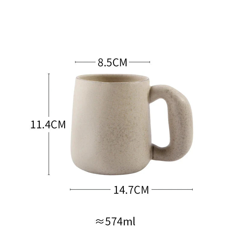 Handcrafted Japanese stoneware retro coffee mug in apricot and grey colors with a comfortable grip and minimalist design