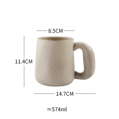Handcrafted Japanese stoneware retro coffee mug in apricot and grey colors with a comfortable grip and minimalist design