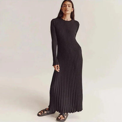 Timeless elegant pleated knit dress in black, perfect for summer office wear with a sophisticated and comfortable design.