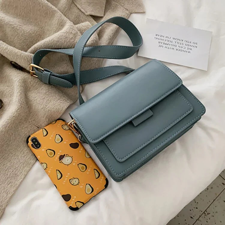 Stylish black crossbody shoulder bag with adjustable strap and multiple interior compartments for modern women
