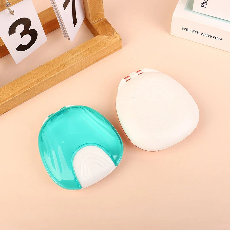 Compact, transparent dental retainer storage box with a push-to-open mechanism for easy access to dental appliances