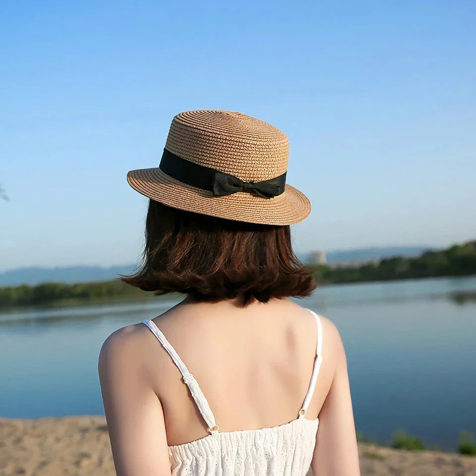 Classic straw Panama hat with a bow detail, offering sun protection and fashionable summer style